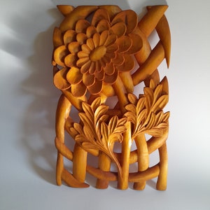 Handmade wooden flower wall carving with carved petals and leaf accents, by Luka's carvings