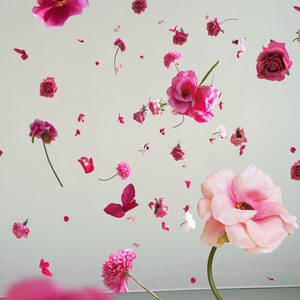 Pink hanging flower garland with layered blossoms and dangling decorative pieces