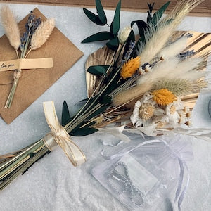 Dried flower gift box with mixed blooms, wrapped ribbon bow and faux grass accents