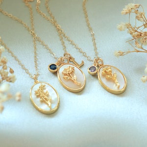 Gold-tone mother-of-pearl birth flower pendant necklace with small gemstone accents