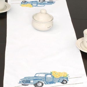 Stamped embroidery table runner kit, blue and yellow flower delivery truck design on white