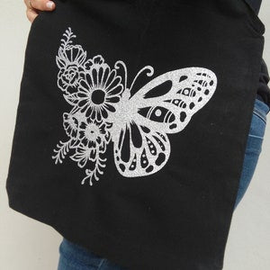 Black tote bag with silver glitter floral butterfly front design