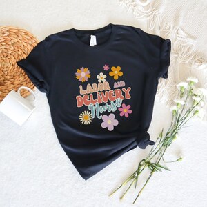 Dark T-shirt with colorful flower graphic and delivery-themed text on front