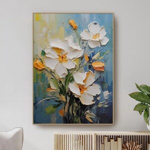 Framed 3D floral wall art with white and orange blossoms on blue textured background