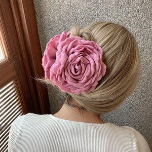 Pink fabric flower hair claw clip with clamp on blonde hair bun