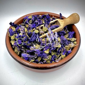 Loose blue mallow dried flowers herbal tea in shallow dish