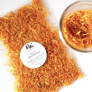 Organic calendula flower petals, dried orange-yellow, with round product label