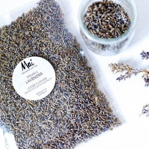 Dried French lavender buds in a small clear jar and loose pile