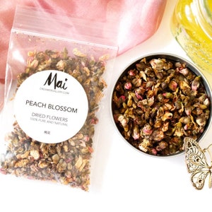 Dried peach blossom whole flowers in a clear pouch and small bowl