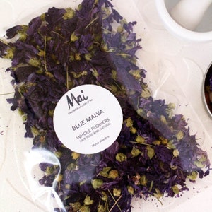 Dried whole blue malva flowers in clear bag, with Mai label