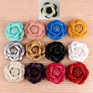 Assorted faux leather flower hair clips with rosette blooms in multiple colors