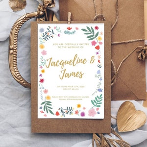 Wedding invitation card with colorful floral border and text, centered on cream paper
