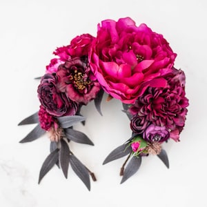 Floral headband with fuchsia pink and purple flowers, green leaves, ribbon bows