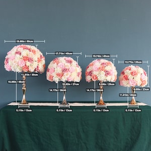 Artificial flower ball centerpiece with pale pink and cream rose-like blooms, round