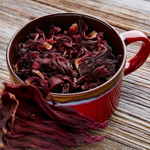 Dried hibiscus petals in ceramic cup, whole flower petal pieces for tea
