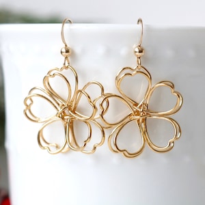 Gold wire-wrapped flower drop earrings with delicate dangling floral design