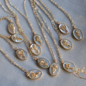 Gold-tone birth flower pendant necklace with oval charm and layered chain