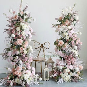 Pale pink and blush floral arch with two matching flower columns for ceremony backdrop