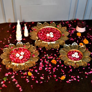 Set of 3 lotus urli bowls with gold-tone filigree and red jeweled candle holders