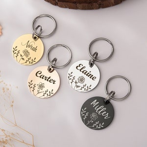 Circular pet name tags with birth flower engraving and small keyring loops