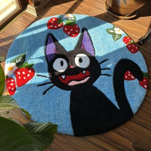 Handmade round tufted anime rug, blue with black cat face and red strawberry bows
