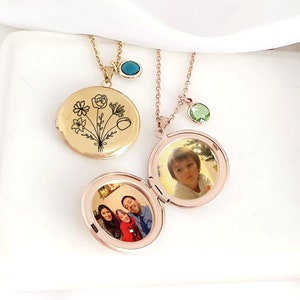 Round gold-tone locket necklace with engraved flower, hinged photo charm and chain