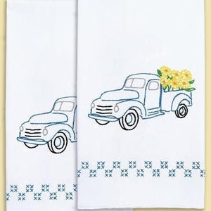 Stamped cross-stitch hand towel with truck and floral border, ready to stitch