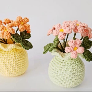 Crochet potted flower plant pattern with yarn pots and blooming crochet blossoms