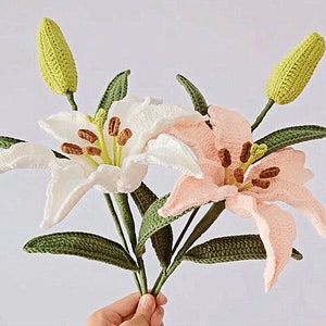 Crochet lily flower bouquet with yellow blooms, green stems, white and pink petals