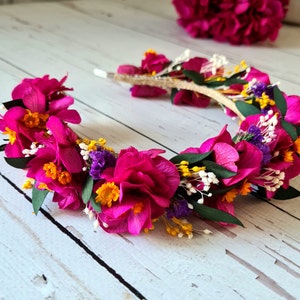 Magenta dried flower headband with small yellow accents on gold-toned stems