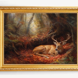 Framed wall art painting of a red deer lying in a forest with antlers