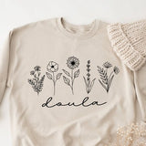 Cream doula sweatshirt with botanical flower line art and 'doula' script