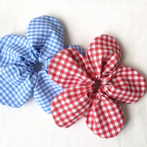 Flower-shaped hair scrunchie with oversized red and blue gingham bow