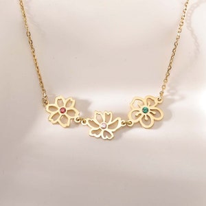 Gold-tone birth flower necklace with pastel enamel blossoms and gemstone centers