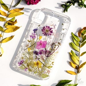 Transparent pressed-flower phone case with pink and purple floral design