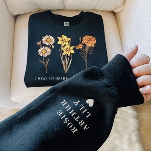 Navy sweatshirt with birth flower graphic and heart quote text