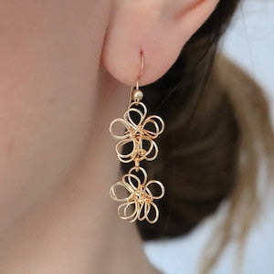 Gold wire-wrapped flower drop earrings with cascading loop filigree