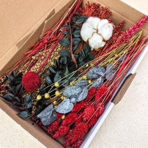 Dried flower DIY mix box with red, blue, and white dried blooms in an open cardboard box