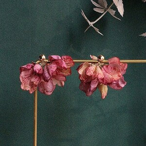 Pink floral clip-on earrings with ruffled petal drops, gold-tone hardware