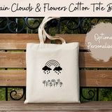 Off-white cotton tote bag with black rainbow and cloud graphic, top handles