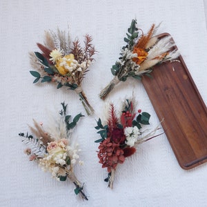 Mini dried flower bouquets with mixed tones, including burgundy, orange, and cream blooms