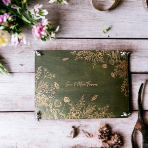 Large botanical flower press, dark green cover with gold floral line art and corners