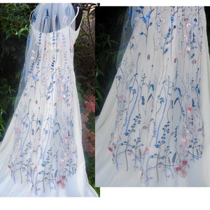 Sheer white wedding veil with blue floral embroidery and light pink accents