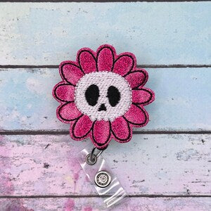 Pink flower badge reel with skull face and retractable metal clip