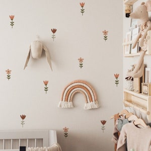 Removable meadow flower wall stickers with small stems and a rainbow arch decal