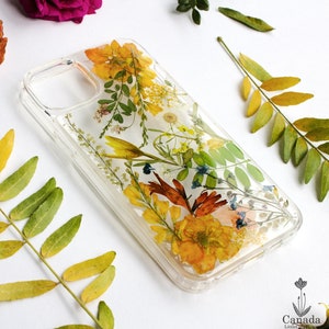 Clear iPhone phone case with pressed flower bouquet in yellow and orange