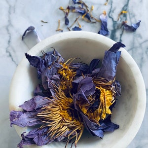 Dried blue lotus flower tea blend in a white bowl