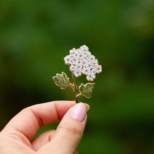 Hawthorn floral enamel pin with pale pink blossom cluster and leafy branch