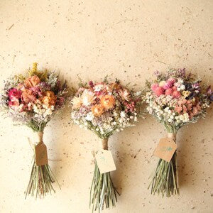 Dried wildflower bouquets with preserved blooms, tied stems, small bridal/bridesmaid sets