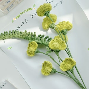 Crochet sweet pea flower bouquet with light green crocheted blossoms